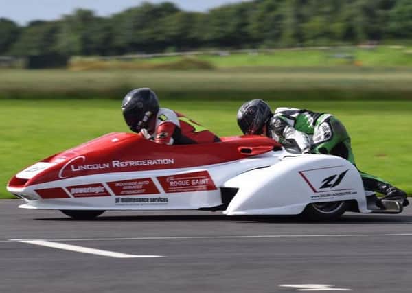 FLYING TO VICTORY -- the Nev Jones sidecar team.