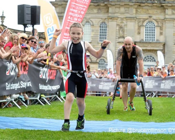 BBC Sport Personality of the Year winner, Bailey Matthews returns to the Castle Howard Triathlon, where he won the hearts of the nation last year by casting aside his walking frame to finish the race. Bailey is nine years old and has cerebral palsy.  Helped by his dad Jono and Uncle John Hardcastle.23 July 2016.  Picture Bruce Rollinson