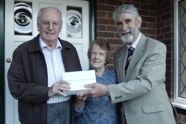 Joe and Mollie Hall are presented with their iPad by John Millard