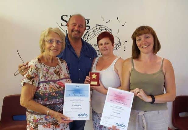 Gainsborough Musical Theatre Society members celebrate with their NODA award