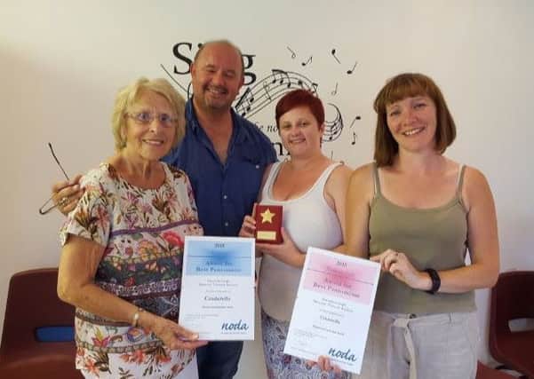 Gainsborough Musical Theatre Society members celebrate with their NODA award
