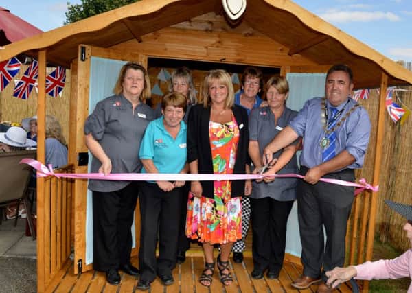 Garden party to celebrate the opening of Foxby Court Care HomeÃ¢Â¬"s new garden and summer house. Gainsborough Mayor Coun Ken Woolley cuts the ribbon with home manager Tracy Turfrey and staff