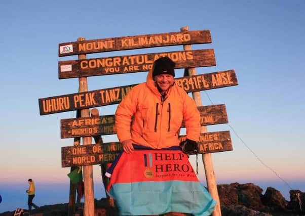 John Mann MP raises The British Legion and Help for Heroes flags on Mount Kilimanjaro