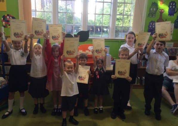 Children celebrate completing the summer reading challenge