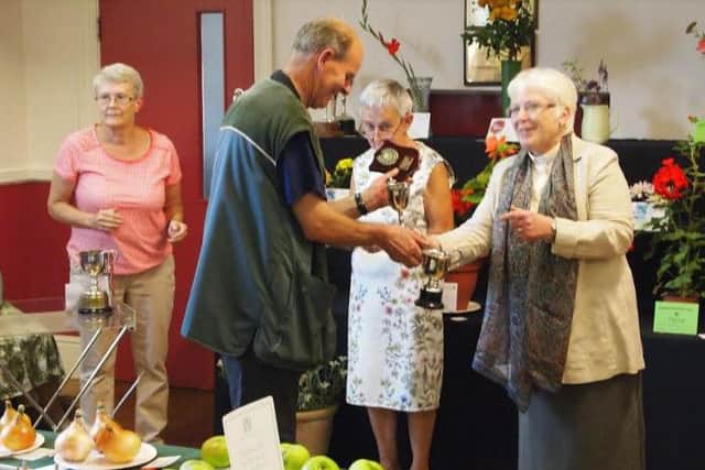 Gary Tyson receives the Aggregate Cup from Rev Pam Rose