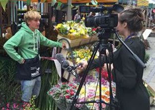 Daniel being interviewed at his stall by a local TV station.
