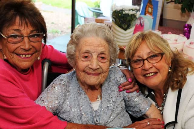 Eileen Hicking gets birthday hugs from her daughters, Elaine Henderson and Mal Richardson when she turned 100 years old at the Victoria Care Home in Worksop on Tuesday.