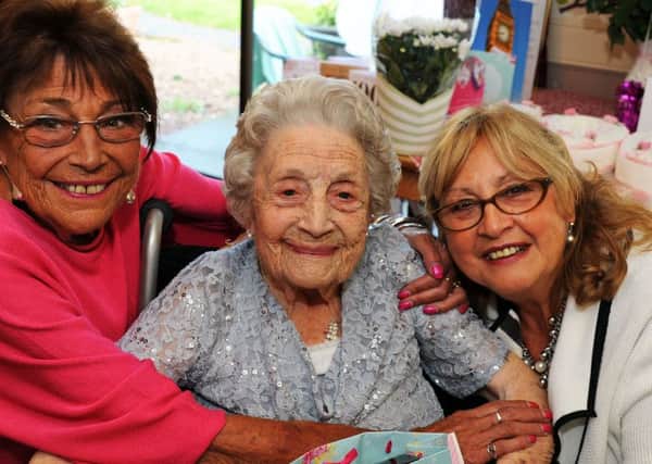 Eileen Hicking gets birthday hugs from her daughters, Elaine Henderson and Mal Richardson when she turned 100 years old at the Victoria Care Home in Worksop on Tuesday.