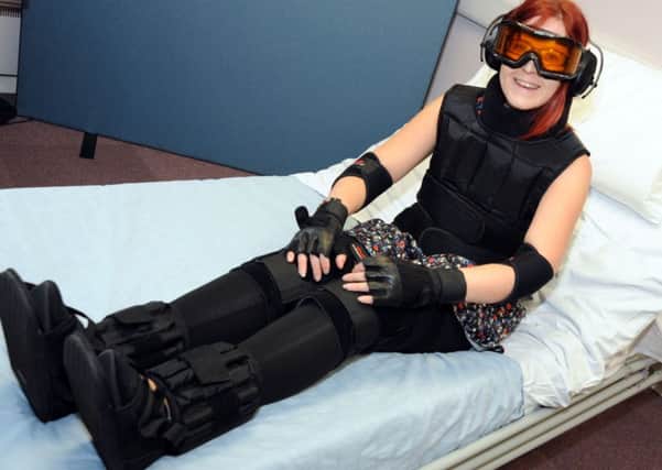 Standard reporter, Shelley Marriot tries to move around with her age simulation suit on.