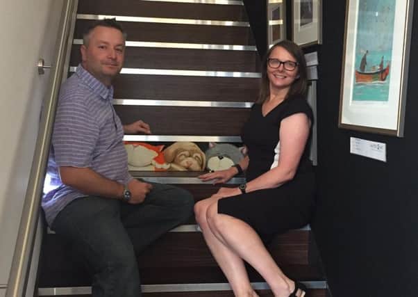 David Smith with gallery owner Ruth Worsman inducting his bespoke piece of art on the gallery's Stairs of Fame