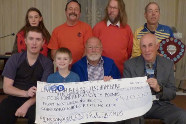 RIDING HIGH -- the presentation of the cycle-ride cheque to the Lincolnshire and Nottinghamshire Air Ambulance.