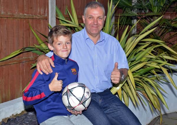 Spencer Presho and his Dad David are off to see Barcelona FC after he used his prized shirt to use as a bandage when a friend was injured in an accident during the summer
