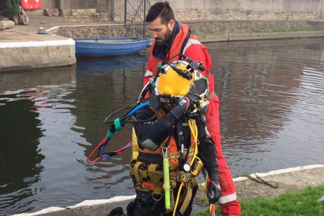 SAVING THE DAY -- a diver preparing to repair the damage at Torksey Lock.