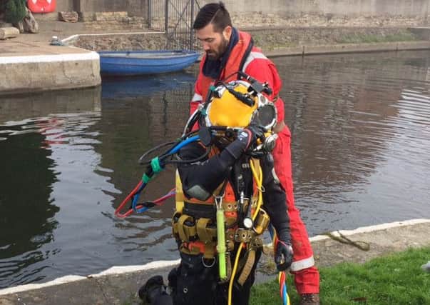 SAVING THE DAY -- a diver preparing to repair the damage at Torksey Lock.