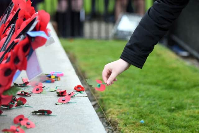 POIGNANT POPPIES -- Remembrance Sunday turned into a sombre occasion for racegoers at Cheltenham's Open meeting.