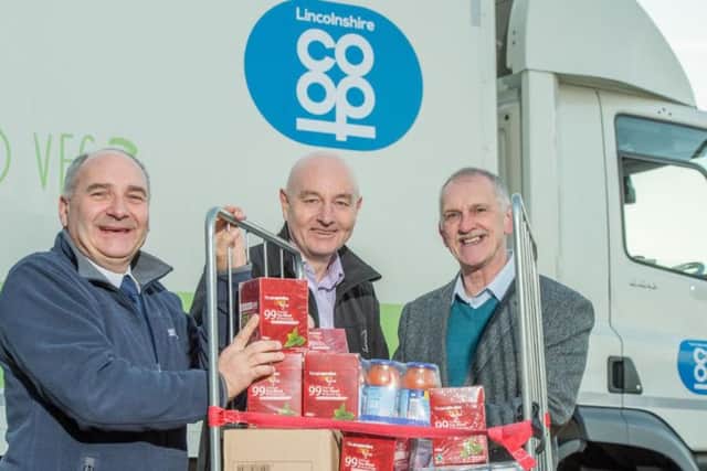 Co-op staff present a grocery donation to Hope's CEO, Alan Diggles.