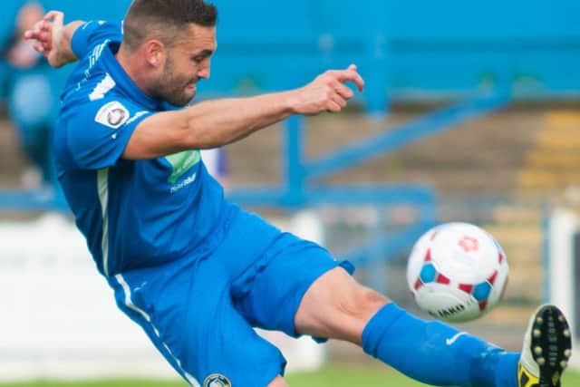 Matt Wilson of gainsborough trinity clearing the ball