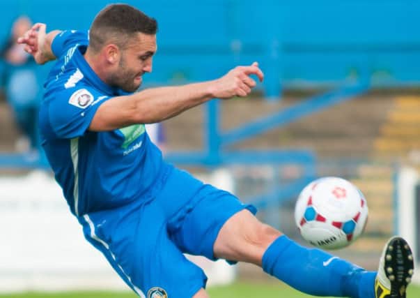 Matt Wilson of gainsborough trinity clearing the ball