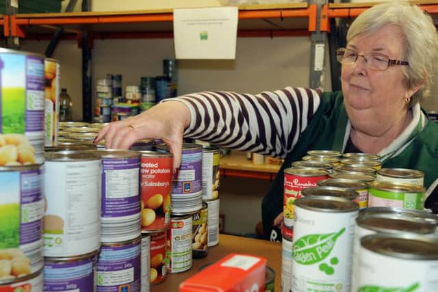 Volunteer, Morag Turner at work in the Lowtown Street food bank.