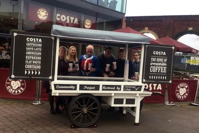 Students and Costa Coffee staff showing that the restored food and drink cart at Marshalls Yard in Gainsborough is ready for business again.