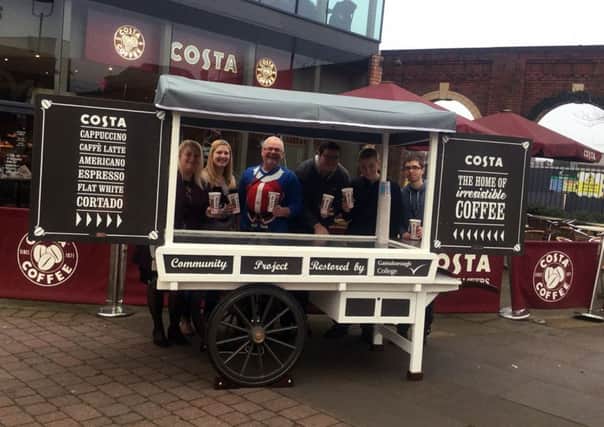 Students and Costa Coffee staff showing that the restored food and drink cart at Marshalls Yard in Gainsborough is ready for business again.