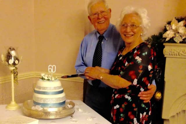 Douglas and Merle Austin, of Gainsborough Road, Lea, cut the celebration cake at their diamond wedding party on New Years Day.