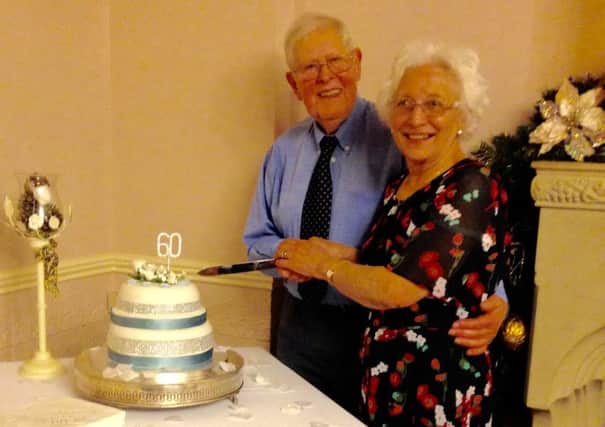 Douglas and Merle Austin, of Gainsborough Road, Lea, cut the celebration cake at their diamond wedding party on New Years Day.