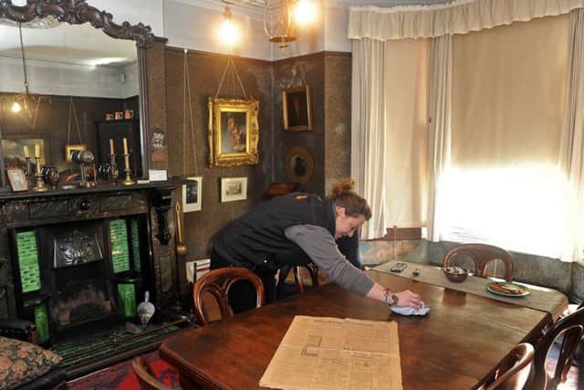 House and visitors services manager, Torri Crapper puts some finishing touches to the front dining room in preparation for the new season.