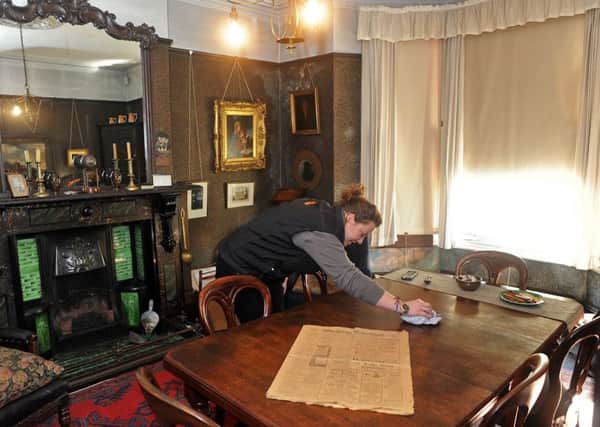 House and visitors services manager, Torri Crapper puts some finishing touches to the front dining room in preparation for the new season.