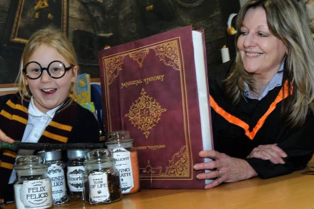 Freya Robinson casts her spells at the Gainsborough Library with cultural service advisor, Gill Blades, during Harry Potter Day.
