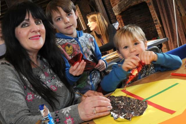 Winter Warriors craft afternoon at the Old Hall, Gainsborough.
Elijah Kirk, 7, and his little brother, Charley, 4, get some help with their designs from their Aunty Rosanna Spencer.