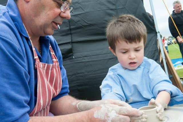 Elliot Pacheco tries his hand at pottery at Wroot Feast