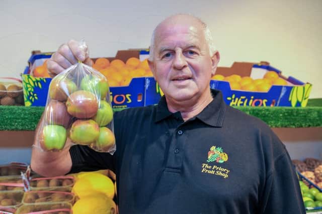 Guardian Freebie, free bag of Braeburn apples from The Priory Fruit Shop. The shop now offers a delivery service, pictured is owner steve