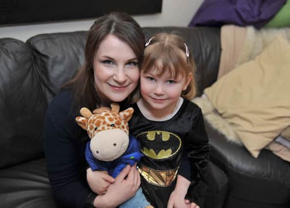 Sarah Bell will be running the London Marathon to raise funds for the Tuberous Sclerosis Association dressed in a Batman costume. Sarah is pictured with Daughter Emily, four