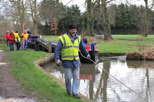 Volunteers pull barge containing new lock gates which are due to be fitted on the Chesterfield Canal near Shireoaks