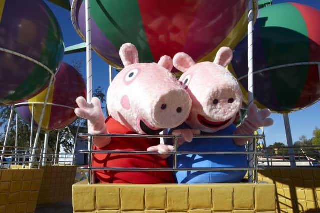 Peppa and George enjoy Peppa's Big Ballon Ride at Peppa Pig World, part of Paultons Family Theme Park in Hampshire.