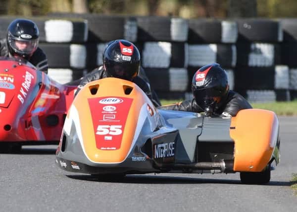 Team SAS, alias sidecar-racers Giles and Jen Stainton, in action on the track. (PHOTO BY: Sid Diggins)
