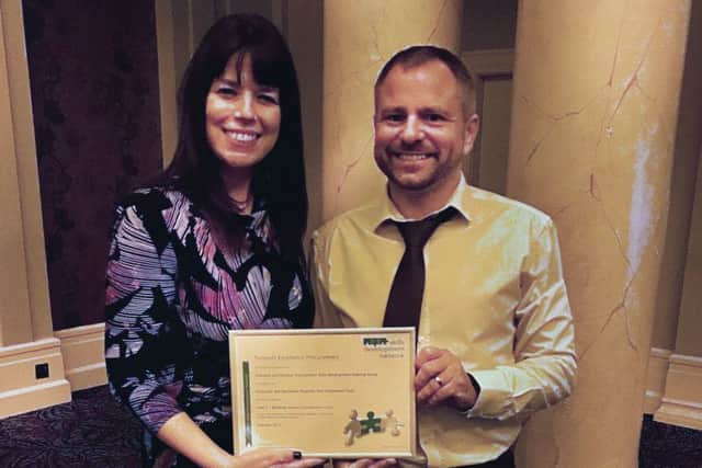 Procurement director Andrea Smith and deputy Richard Somerset receiving the award.