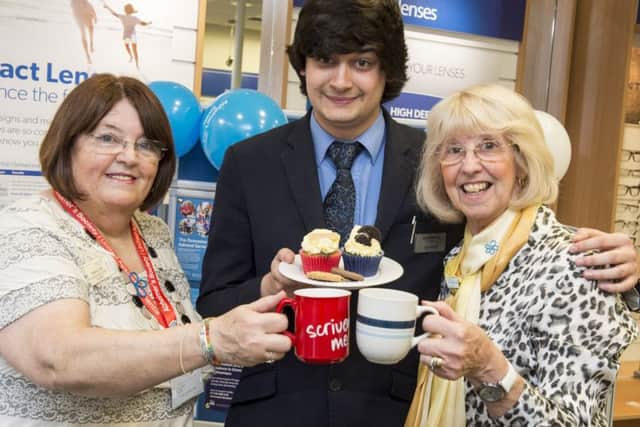 Alzheimers Society Dementia Support Worker, Sheena Carr having tea and cake with sales adviser Aaron Walton and volunteer Doreen Merrills in the Doncaster branch of Scrivens
