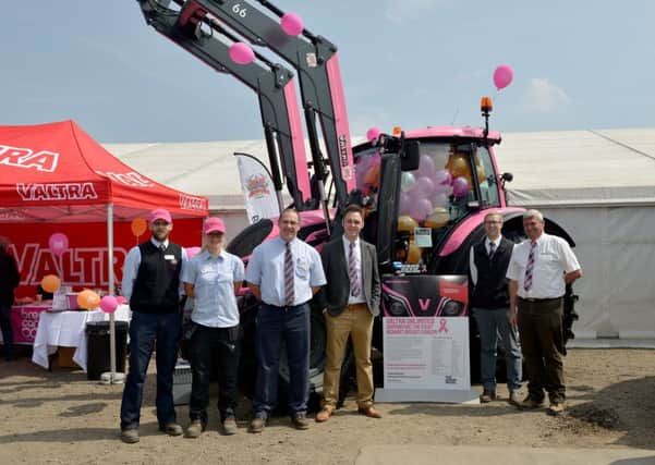 Employees of Peacock and Binnington showing off the impressive, fundraising pink Valtra tractor at the open day.