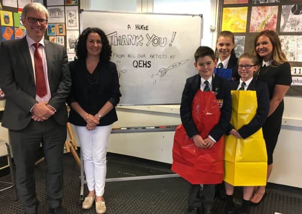 David Allsop (left), head teacher at Queen Elizabeth's High school, with Tracey Coulson and (far right) head of art Emily Walsh with pupils in the new aprons