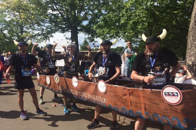 Weve done it! The four Viking longboat runners celebrate after completing the marathon in a world-record time.