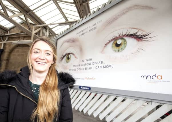 Gemma at the railway station with the poster.