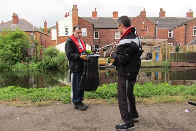 Volunteers from Autism East Midlandss Tall Trees day service in Retford help tidy up their stretch of the Chesterfield Canal