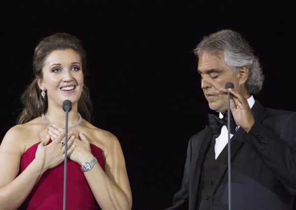 Carly Paoli on stage with Andrea Bocelli.