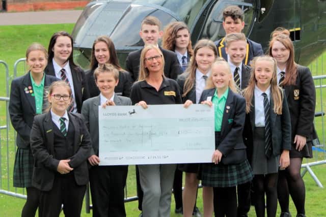 Students involved in the fundraising are pictured presenting the cheque to Karen Carter of Lincs & Notts Air Ambulance.