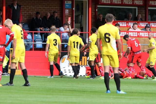 Gainsboroughs Tom Davie gets a straight red card for a late tackle on Alfretons Ryan Jennings.
