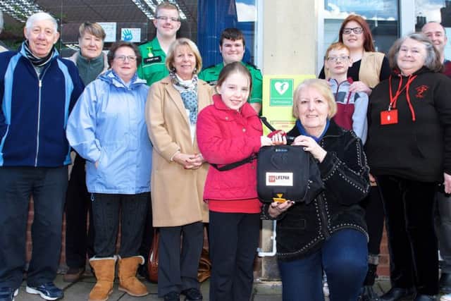 Coun Sheila Bibb with the community defibrillator installed at the Connexions Community Hub on Church Street through fundraising activities with St Johns Ambulance Gainsborough, the Performing Arts Club St Johns, National Citizens Service and the Gainsboroughs Heart Support Group