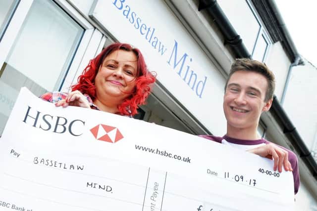 Jack Mckinnel hands over the proceeds of the sky dive he did in July, totalling £662, which he presented to Bassetlaw Mind's chief executive, Nic Roberts, on Monday.
