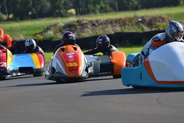 The husband-and-wife sidecar-racing team, Giles and Jen Stainton, in action at Cadwell Park. (PHOTO BY: Sid Diggins)